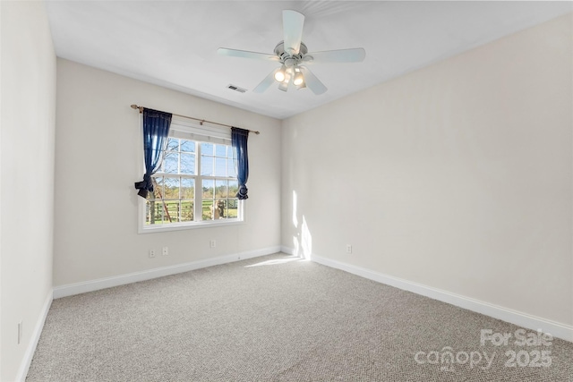 spare room featuring a ceiling fan, carpet, visible vents, and baseboards