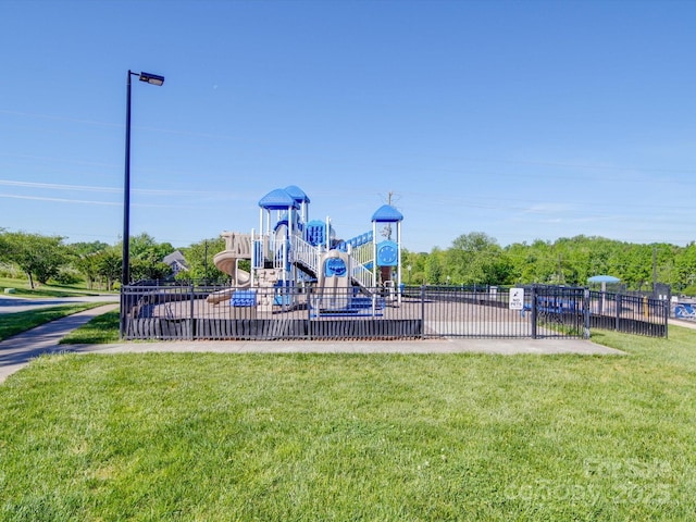 community playground with fence and a yard