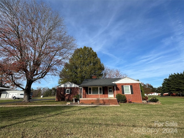 single story home with a front yard and a porch