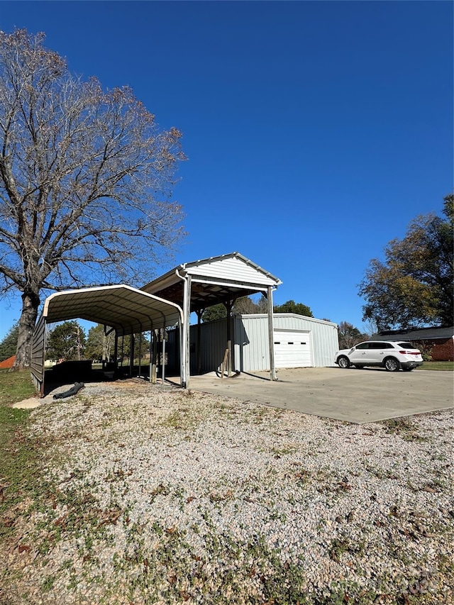 exterior space with a garage, an outdoor structure, and a carport