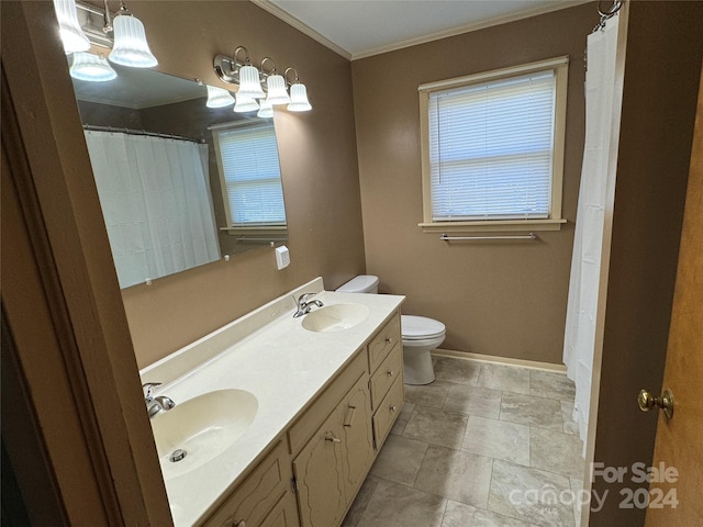 bathroom featuring vanity, toilet, and crown molding