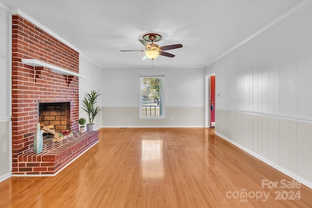 unfurnished living room with a fireplace, ceiling fan, light hardwood / wood-style flooring, and ornamental molding