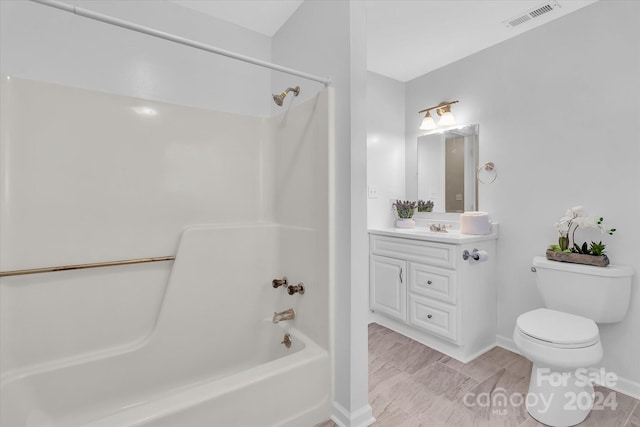 full bathroom featuring toilet, vanity, and tub / shower combination