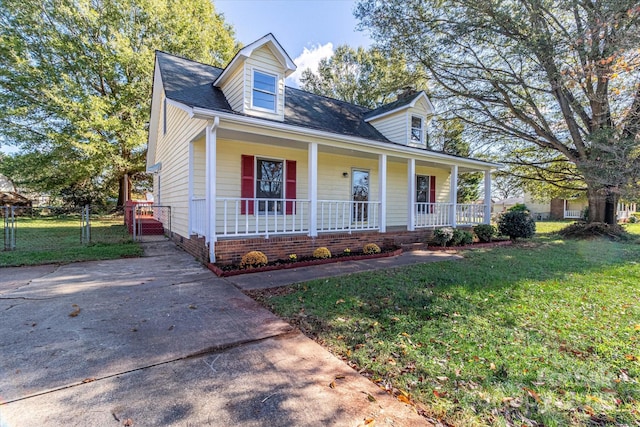 cape cod-style house featuring a gate, fence, a porch, and a front lawn