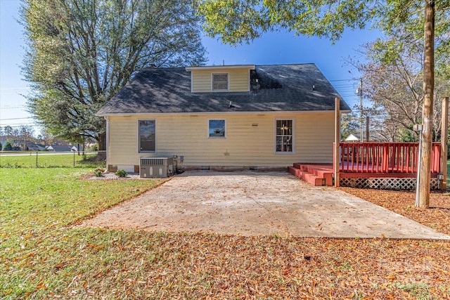 back of property featuring a patio, a wooden deck, crawl space, central AC, and a lawn