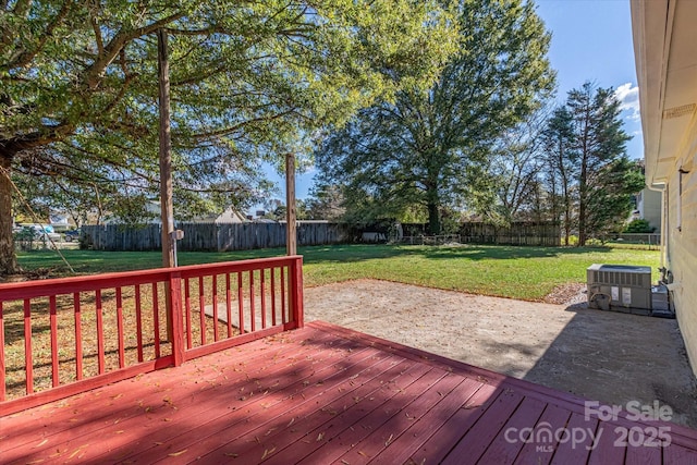 deck with central AC unit, a yard, a patio, and a fenced backyard