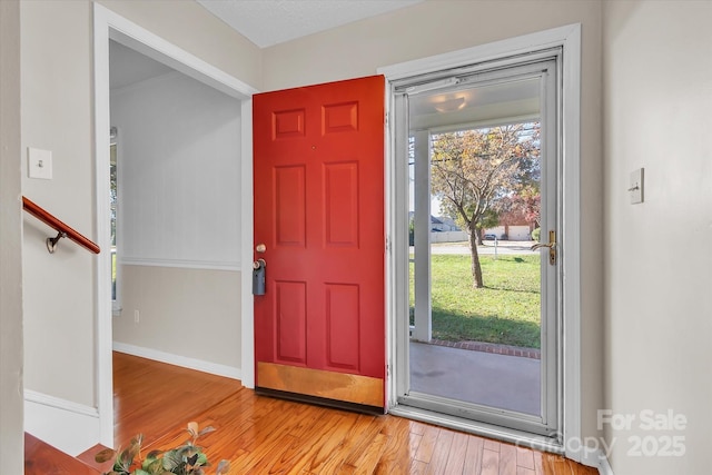 entrance foyer featuring wood finished floors and baseboards