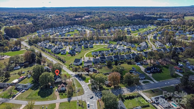 aerial view with a wooded view and a residential view