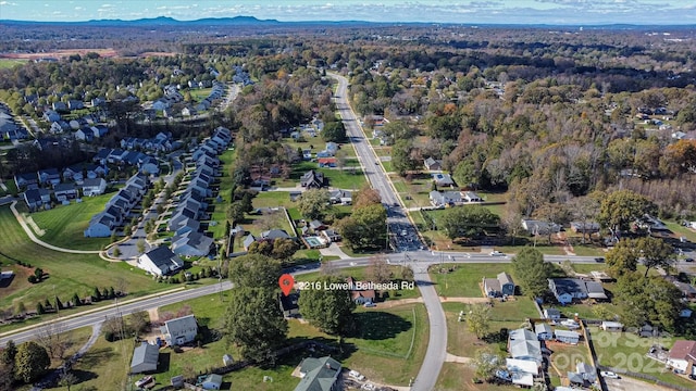 bird's eye view with a wooded view and a residential view