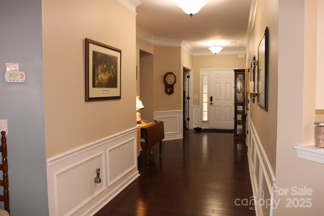 corridor with dark hardwood / wood-style floors and crown molding