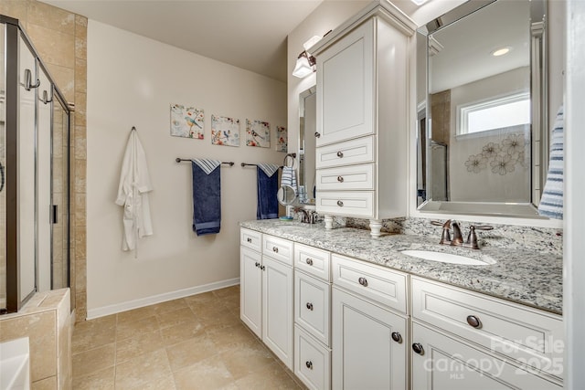 bathroom with vanity and a shower with door