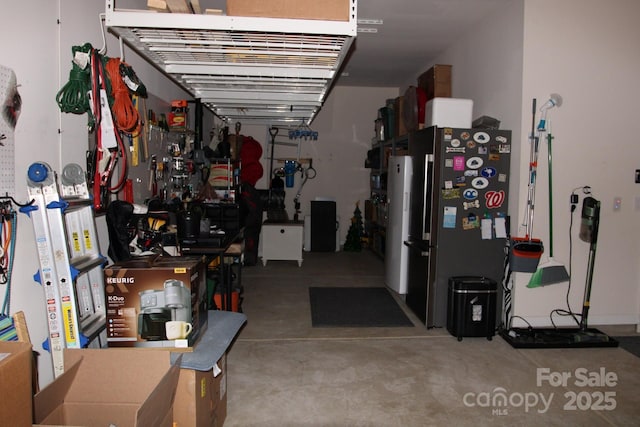 garage featuring a workshop area and stainless steel refrigerator