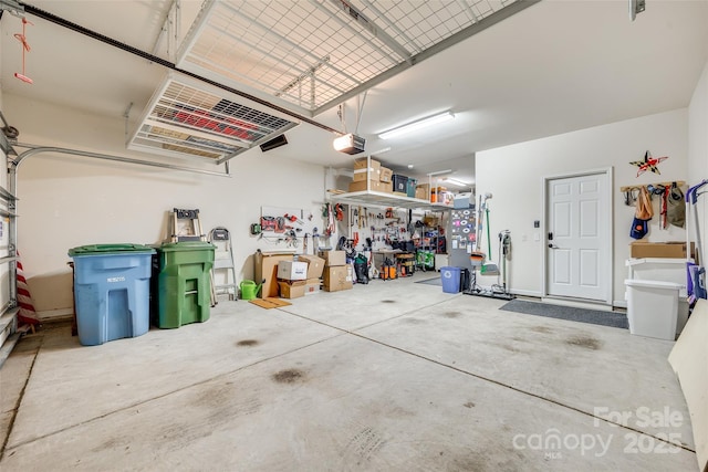 garage with a workshop area and a garage door opener