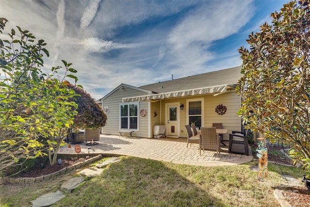 rear view of property featuring a patio