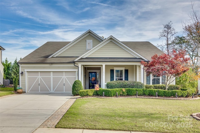 view of front of house featuring a front yard, a porch, a garage, and central air condition unit