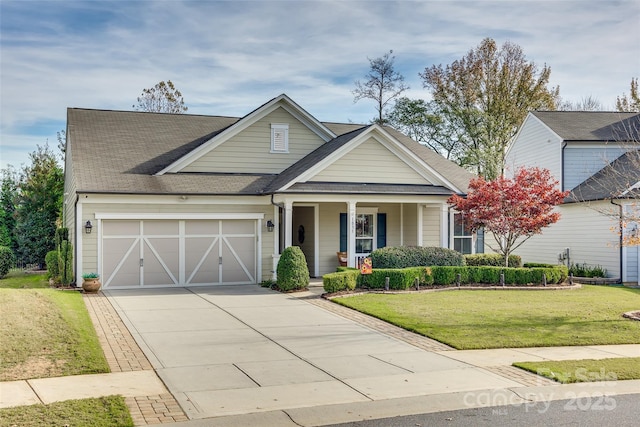 view of front facade with a garage, a porch, and a front lawn