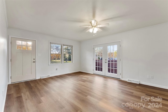 interior space featuring ceiling fan, hardwood / wood-style floors, french doors, and ornamental molding