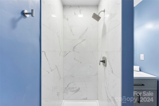 bathroom featuring vanity and a tile shower