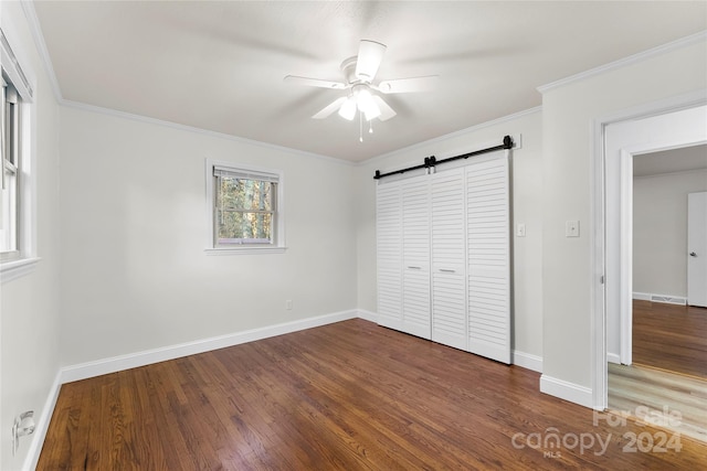 unfurnished bedroom featuring ceiling fan, dark wood-type flooring, and ornamental molding