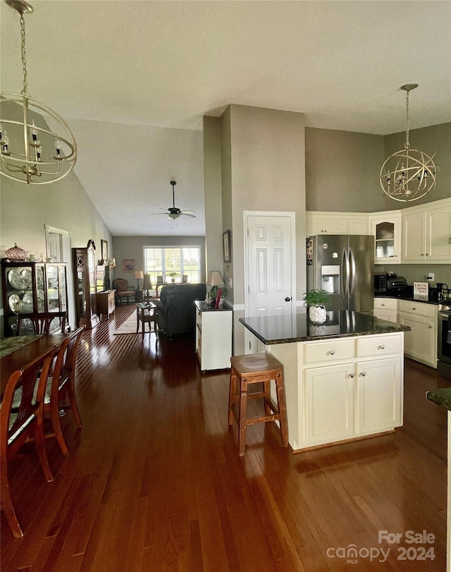 kitchen featuring decorative light fixtures, a breakfast bar area, white cabinets, ceiling fan with notable chandelier, and appliances with stainless steel finishes