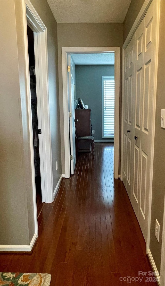 hallway with dark hardwood / wood-style floors