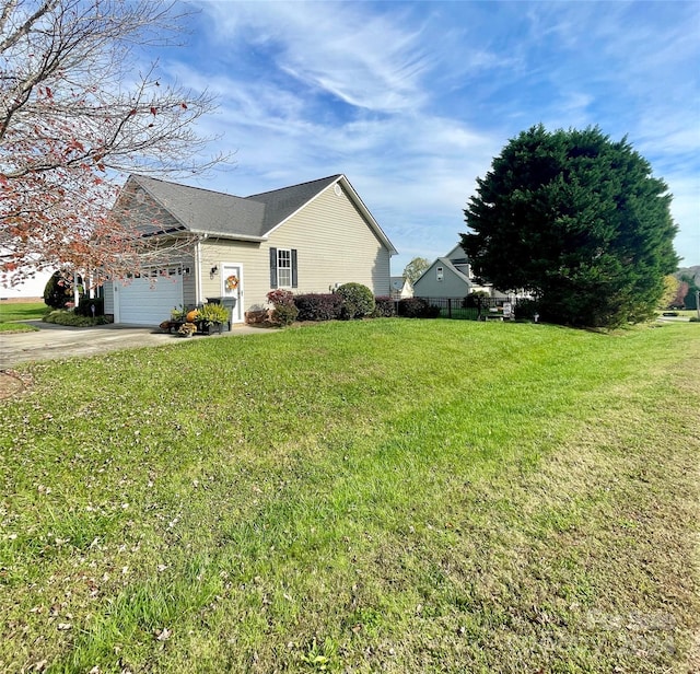 view of side of property with a garage and a lawn