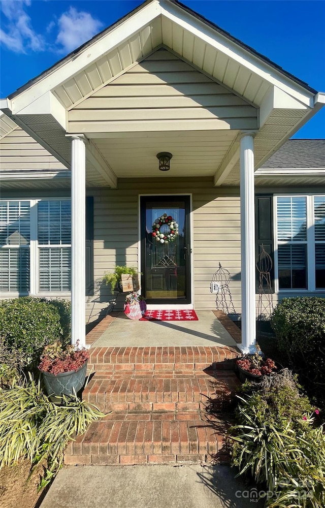 view of exterior entry with covered porch