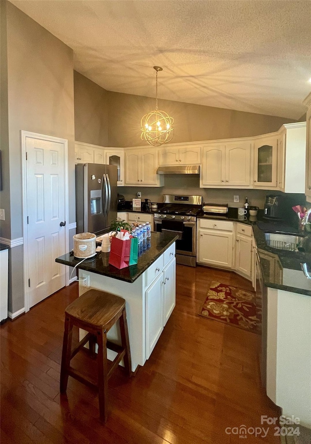 kitchen featuring white cabinetry, sink, pendant lighting, a kitchen island, and appliances with stainless steel finishes