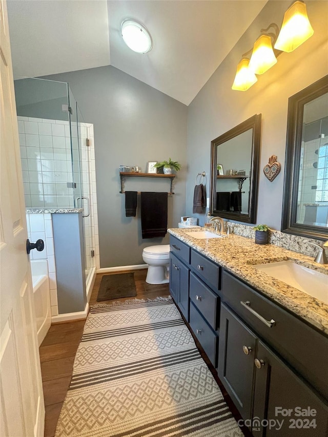 full bathroom featuring vanity, vaulted ceiling, hardwood / wood-style flooring, independent shower and bath, and toilet