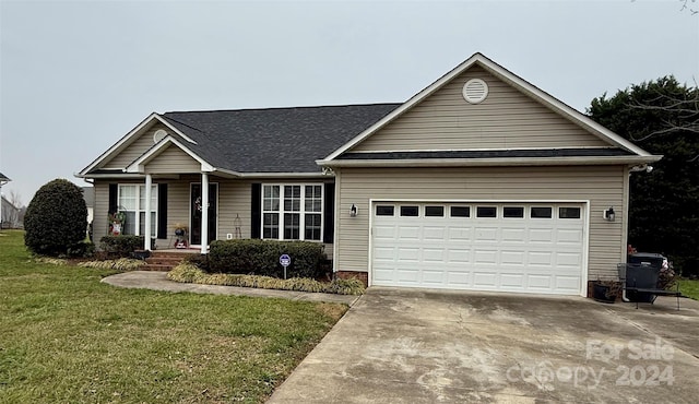 single story home with a garage and a front lawn