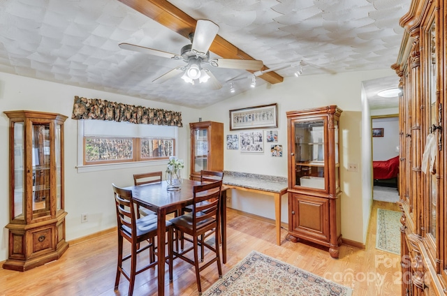 dining room with vaulted ceiling with beams, ceiling fan, and light hardwood / wood-style floors