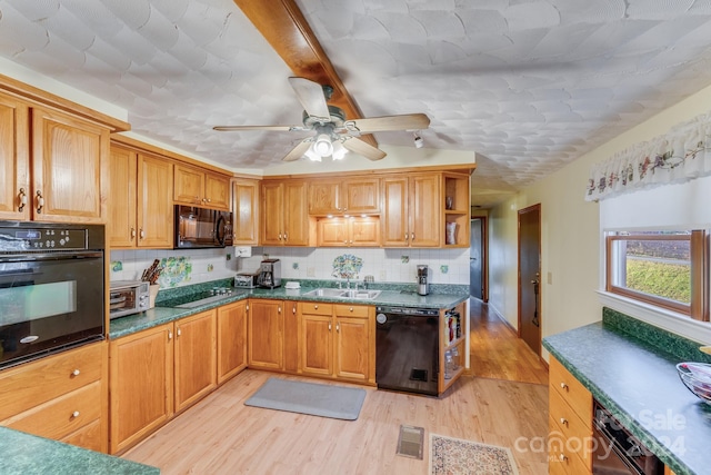 kitchen featuring backsplash, ceiling fan, sink, black appliances, and light hardwood / wood-style floors