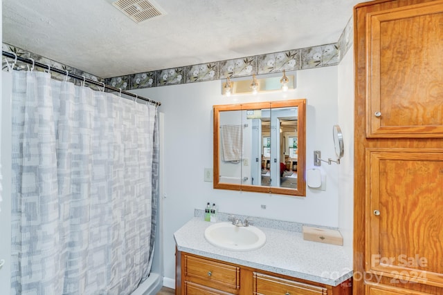 bathroom featuring curtained shower and vanity