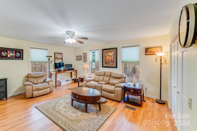 living room with ceiling fan and light hardwood / wood-style floors