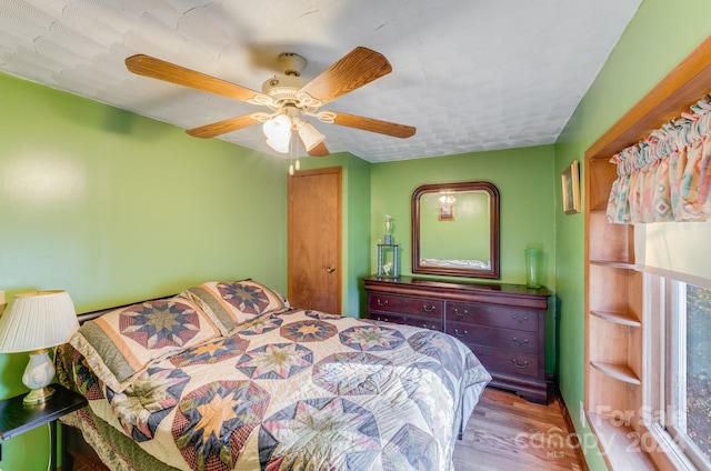 bedroom with hardwood / wood-style flooring and ceiling fan