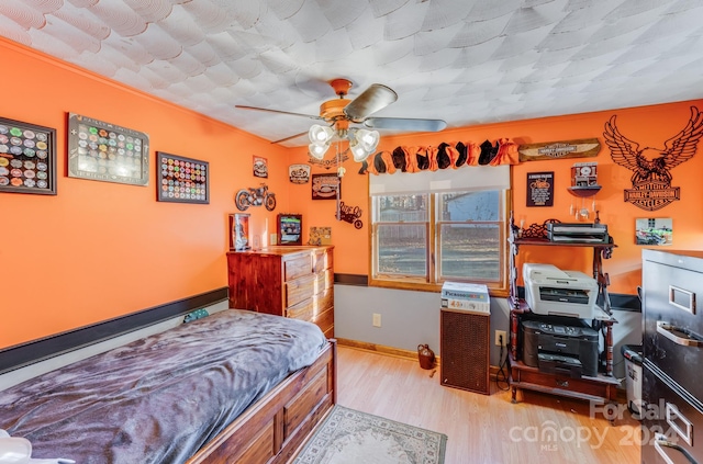 bedroom with ceiling fan and light hardwood / wood-style flooring