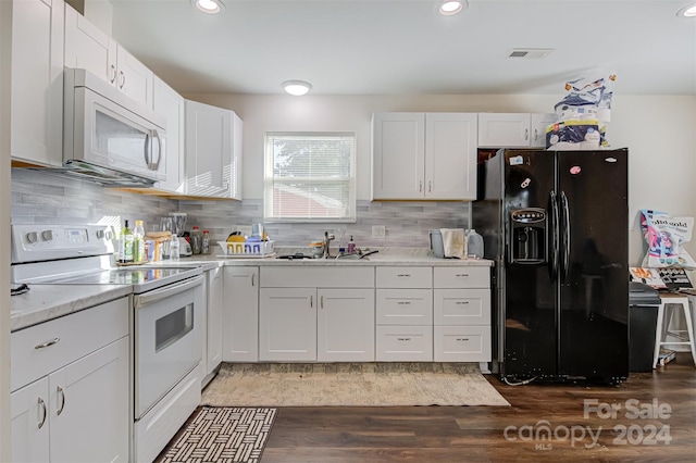 kitchen featuring white cabinetry, sink, dark wood-type flooring, tasteful backsplash, and white appliances