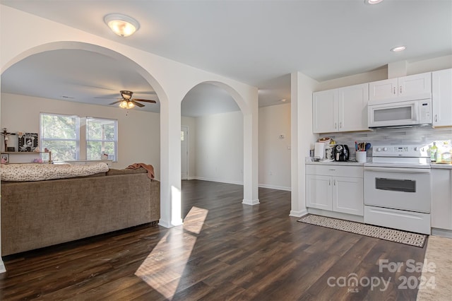 kitchen featuring white cabinetry, ceiling fan, tasteful backsplash, dark hardwood / wood-style flooring, and white appliances