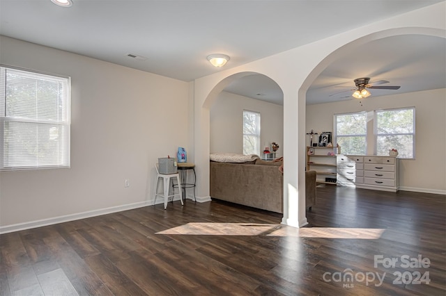 interior space featuring ceiling fan and dark wood-type flooring