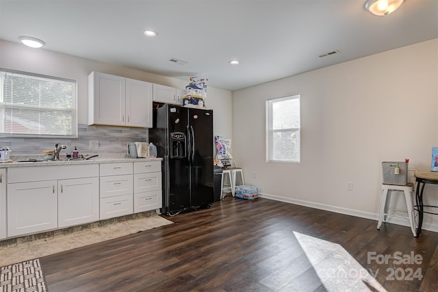 kitchen featuring tasteful backsplash, black fridge with ice dispenser, dark wood-type flooring, sink, and white cabinets