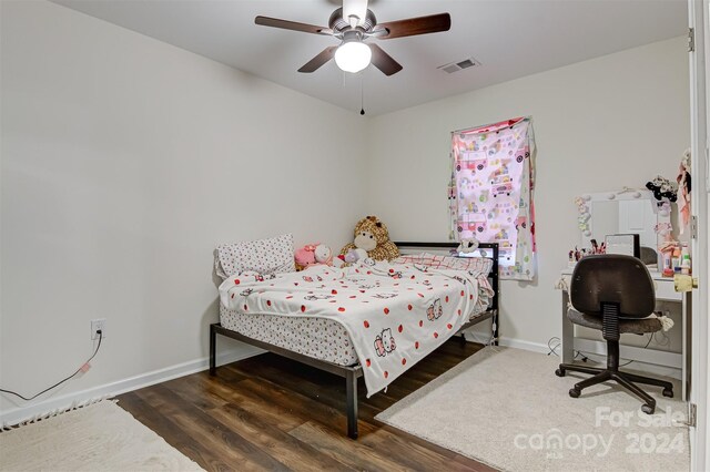 bedroom featuring ceiling fan and dark hardwood / wood-style floors