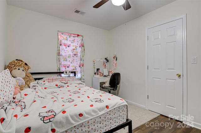 bedroom with dark hardwood / wood-style floors and ceiling fan