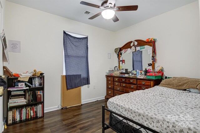 bedroom with ceiling fan and dark wood-type flooring