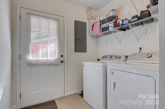 washroom with dark wood-type flooring, electric panel, and washing machine and clothes dryer