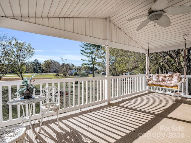 wooden deck featuring ceiling fan