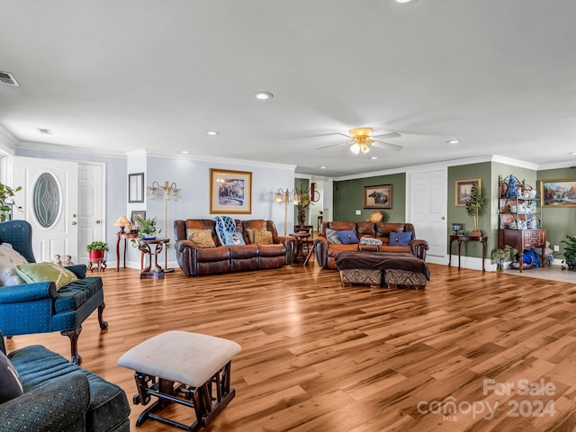 living room with ceiling fan, light hardwood / wood-style flooring, and ornamental molding