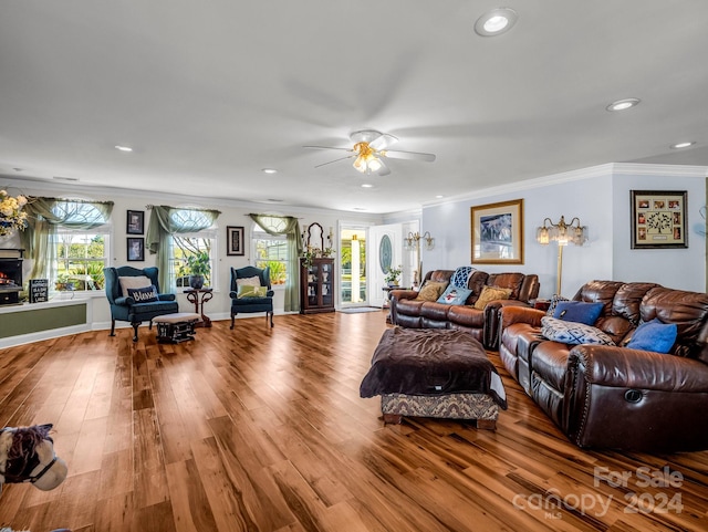 living room featuring ceiling fan, light hardwood / wood-style floors, and ornamental molding