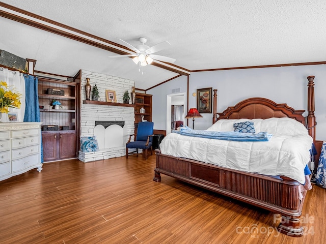 bedroom with a textured ceiling, ceiling fan, hardwood / wood-style floors, and lofted ceiling