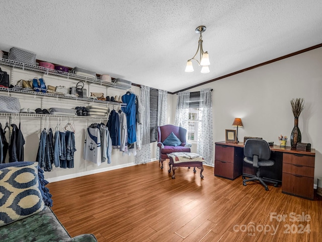 office area with hardwood / wood-style floors, a chandelier, a textured ceiling, and ornamental molding