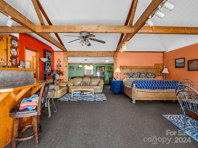 bedroom with dark colored carpet and vaulted ceiling with beams